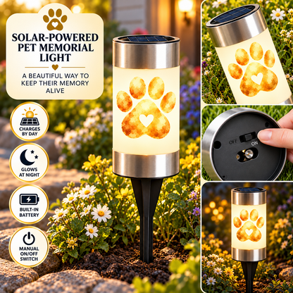 Personalized paw print pet memorial solar light with a pet photo glowing in a garden at dusk